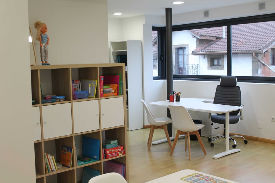 Mesa de trabajo y estanterías con juegos y materiales de logopedia